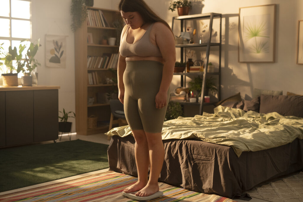 obese woman on the scale weight loss supplement